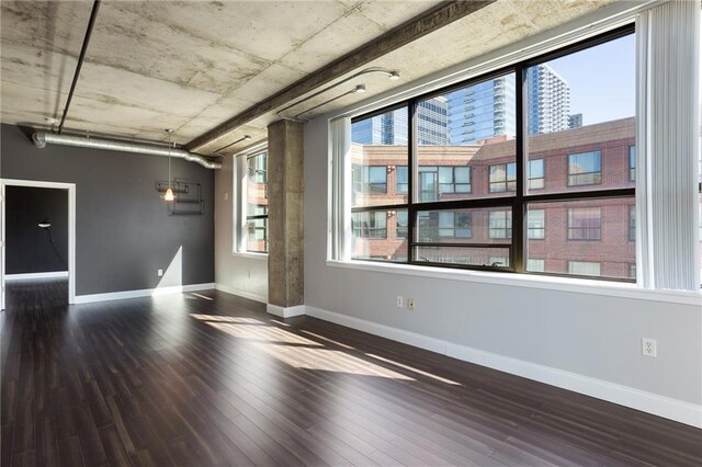 115 W Peachtree Pl NW Unit 602, Atlanta, GA 30313 - spare room featuring wood finished floors, healthy amount of natural light, baseboards, and a city view