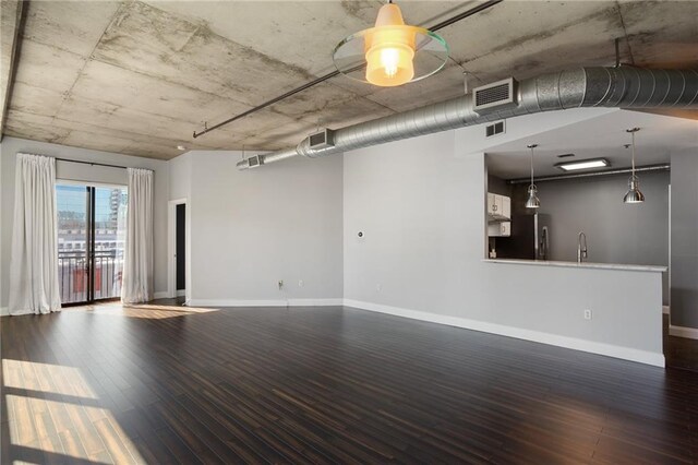 115 W Peachtree Pl NW Unit 602, Atlanta, GA 30313 - unfurnished living room featuring dark wood-type flooring, a sink, and baseboards