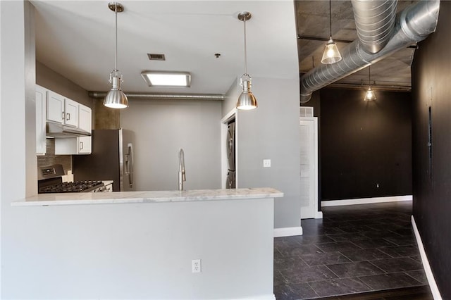 115 W Peachtree Pl NW Unit 602, Atlanta, GA 30313 - kitchen with under cabinet range hood, stainless steel appliances, a sink, baseboards, and white cabinetry
