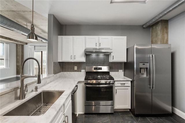 115 W Peachtree Pl NW Unit 602, Atlanta, GA 30313 - kitchen with stainless steel appliances, a sink, light stone counters, white cabinetry, and under cabinet range hood