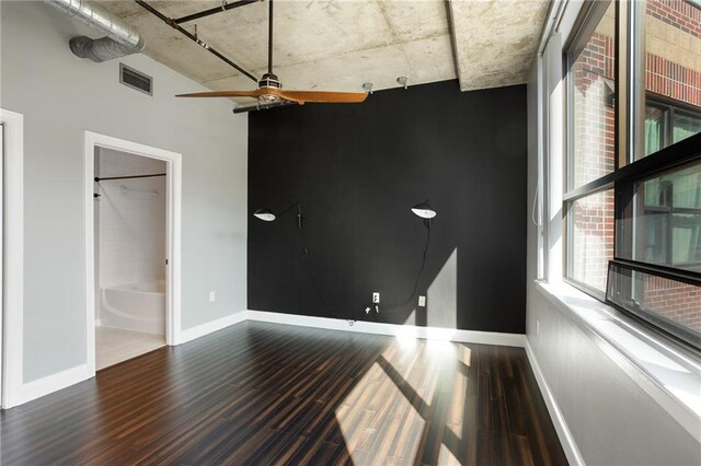 115 W Peachtree Pl NW Unit 602, Atlanta, GA 30313 - unfurnished bedroom with wood finished floors, baseboards, and connected bathroom