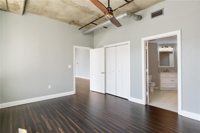 115 W Peachtree Pl NW Unit 602, Atlanta, GA 30313 - unfurnished bedroom with wood finished floors, baseboards, a closet, and a towering ceiling