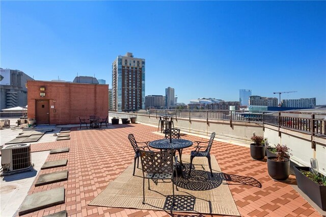 115 W Peachtree Pl NW Unit 602, Atlanta, GA 30313 - view of patio / terrace with a view of skyline and central AC