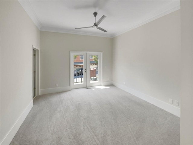 empty room with ceiling fan, ornamental molding, french doors, and light carpet