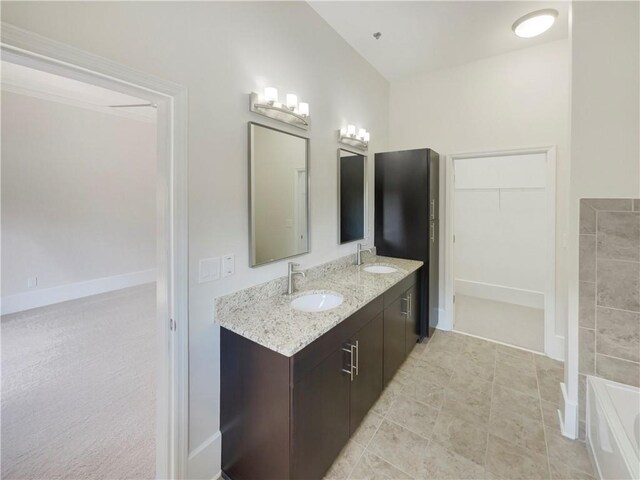 bathroom featuring tile patterned flooring and dual bowl vanity