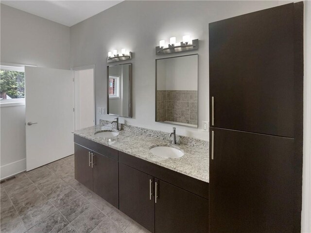 bathroom featuring tile patterned flooring and double sink vanity