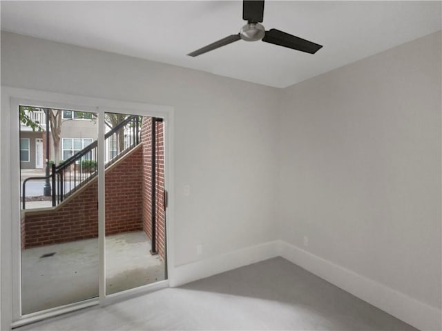 empty room with ceiling fan and concrete flooring