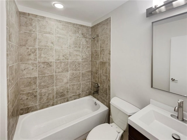 full bathroom with tiled shower / bath combo, toilet, and vanity