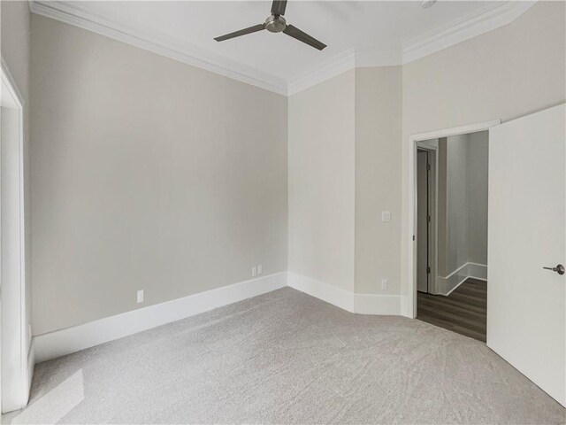 empty room featuring carpet, crown molding, and ceiling fan