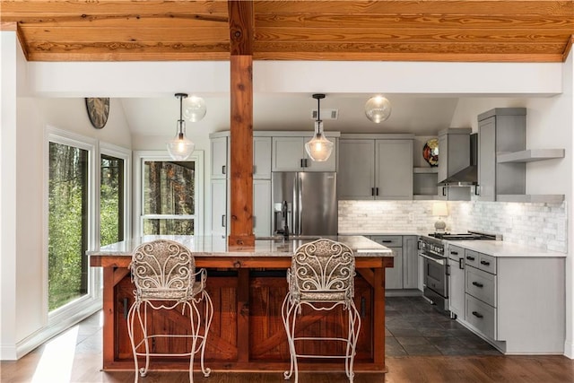 kitchen with gray cabinetry, light stone countertops, stainless steel appliances, and a kitchen island