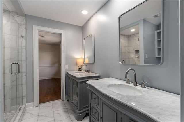 bathroom with a shower with door and vanity