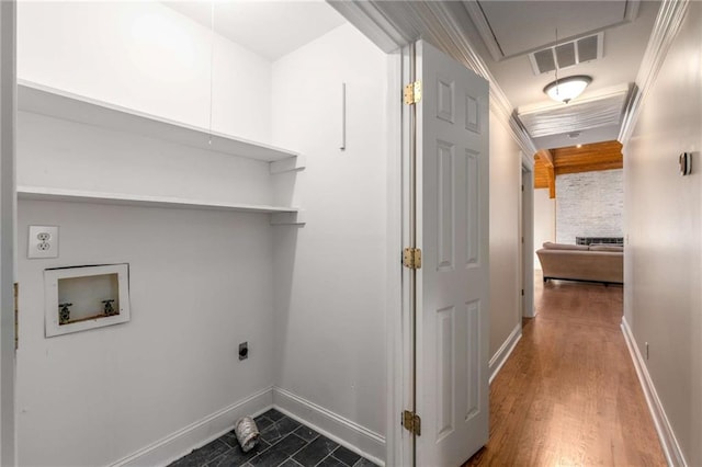 clothes washing area with ornamental molding, hookup for an electric dryer, dark hardwood / wood-style flooring, and hookup for a washing machine