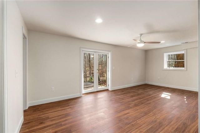 spare room with dark wood-type flooring and ceiling fan