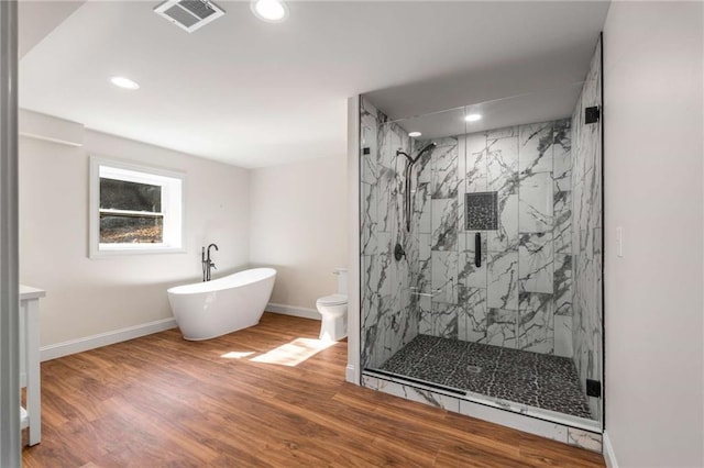 bathroom featuring hardwood / wood-style flooring, shower with separate bathtub, and toilet