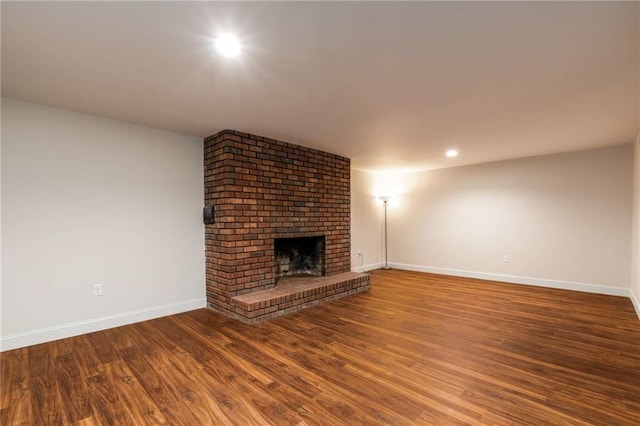 unfurnished living room with wood-type flooring and a fireplace