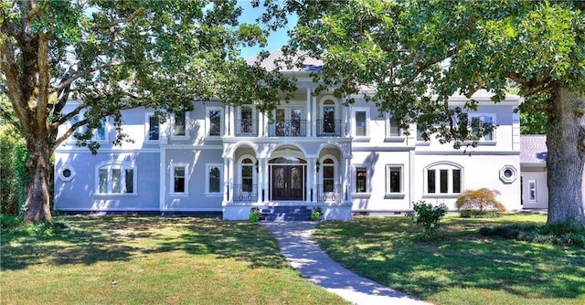 view of front of house with a front yard and stucco siding