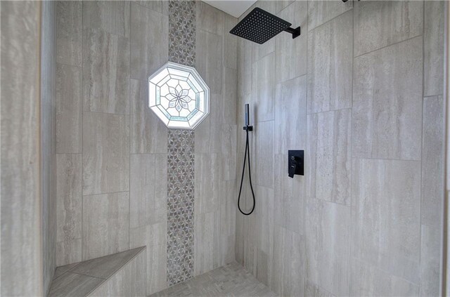 bathroom with tile patterned floors, crown molding, vanity, and a relaxing tiled tub