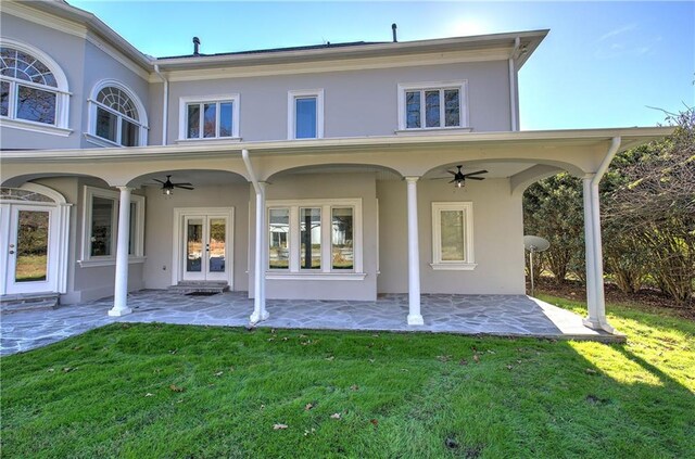 back of property featuring french doors, a yard, and ceiling fan