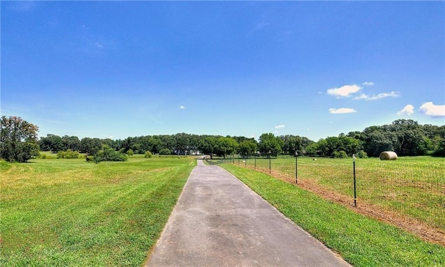 view of gate featuring a yard and a rural view