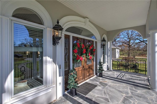 view of exterior entry featuring a porch