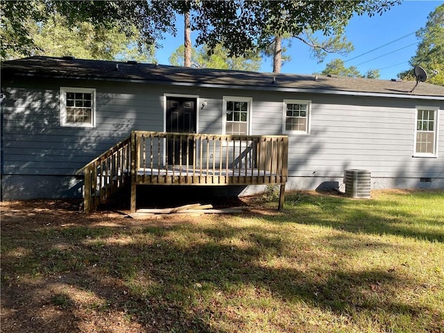 rear view of house featuring a wooden deck, a lawn, and central air condition unit