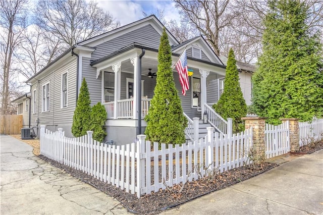 view of front of home featuring ceiling fan, central AC, a porch, and a fenced front yard