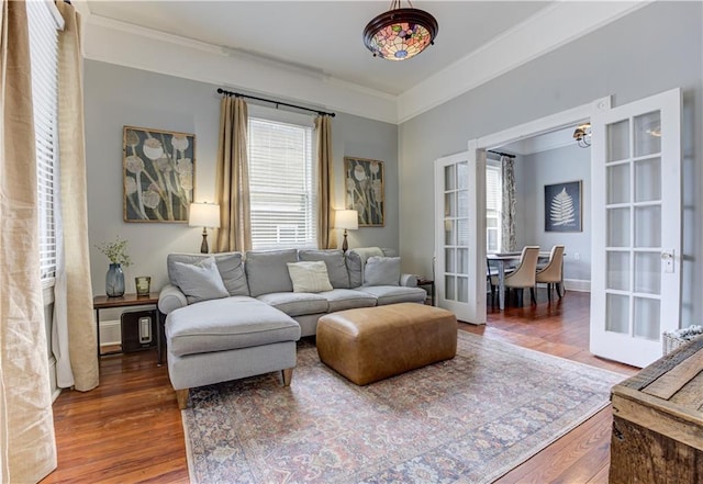 living room with ornamental molding, french doors, and wood finished floors