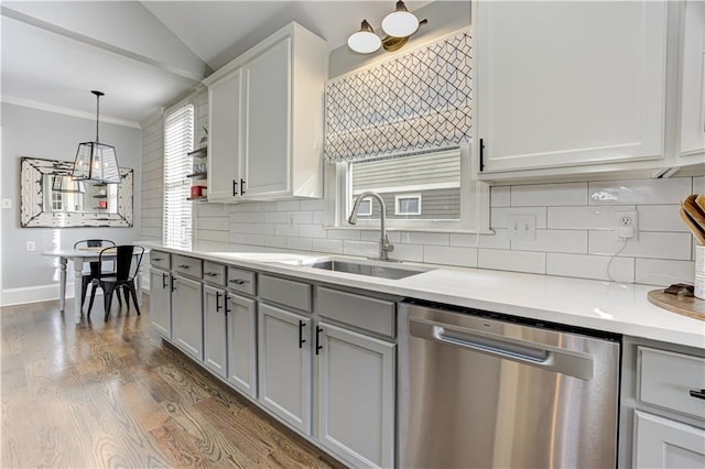 kitchen featuring dark wood-type flooring, gray cabinets, dishwasher, and a sink