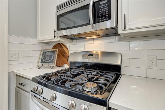 kitchen with stainless steel appliances and backsplash