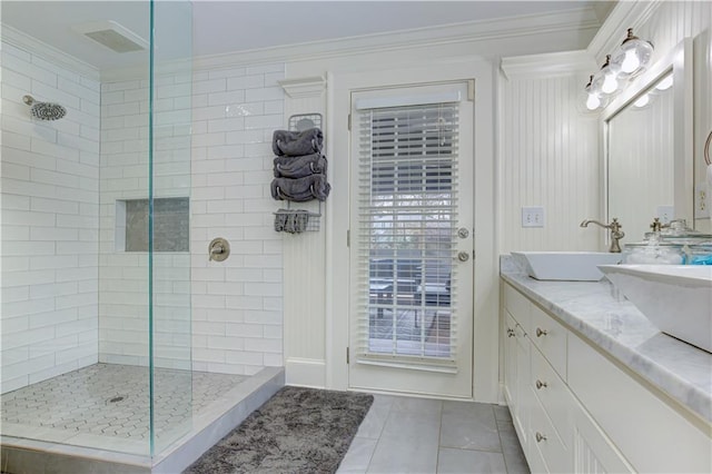 full bathroom featuring a walk in shower, tile patterned floors, a sink, and crown molding