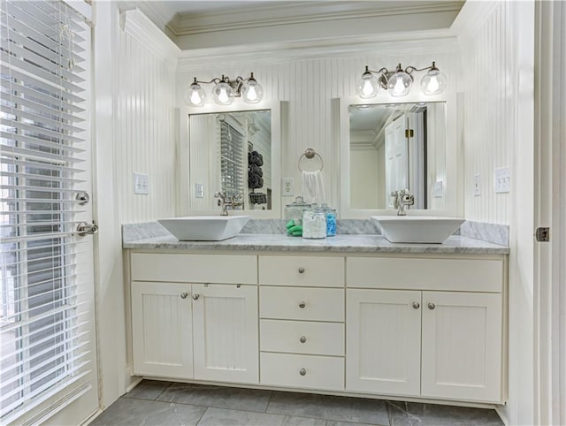 bathroom featuring double vanity, ornamental molding, and a sink