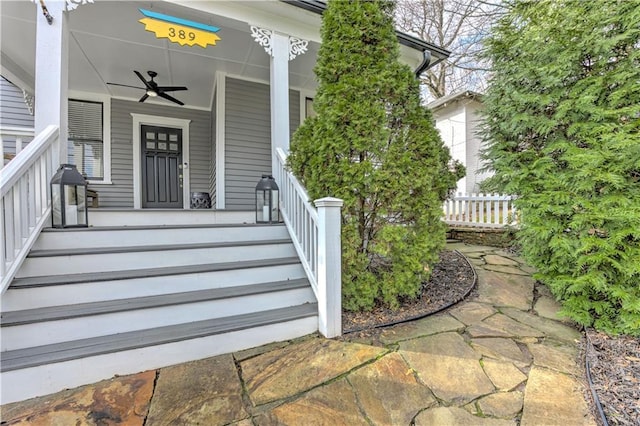 view of exterior entry featuring covered porch