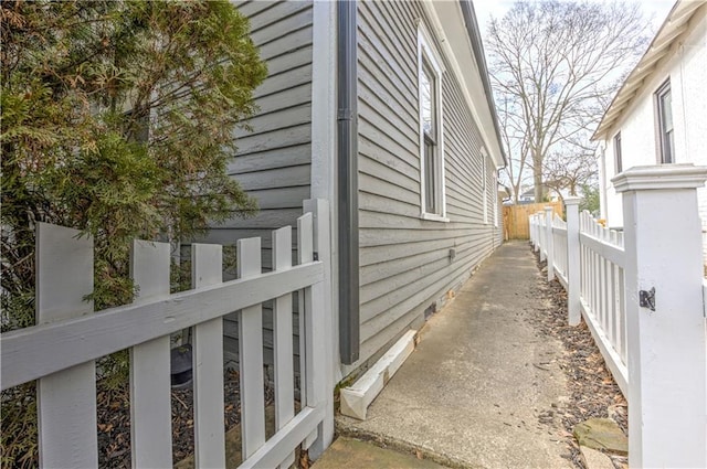 view of side of home featuring fence