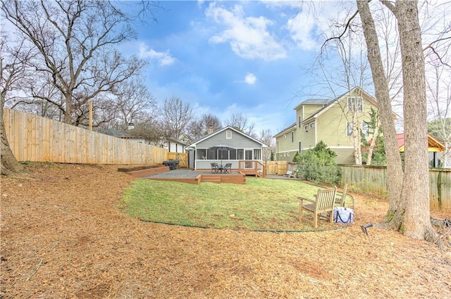 view of yard with a sunroom and a fenced backyard