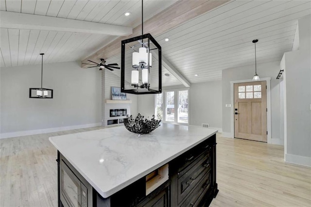 kitchen featuring a center island, pendant lighting, and a fireplace