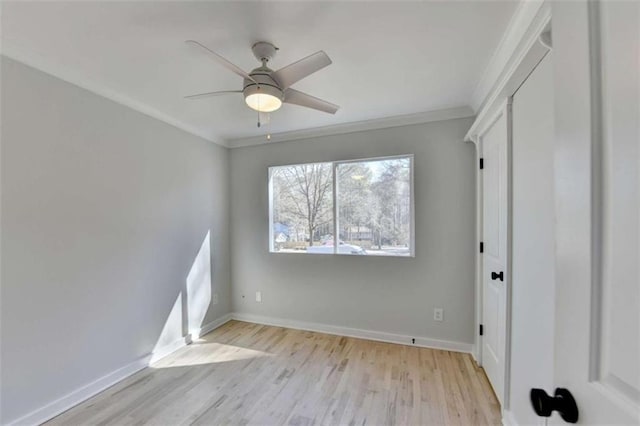 unfurnished bedroom with crown molding, ceiling fan, and light wood-type flooring