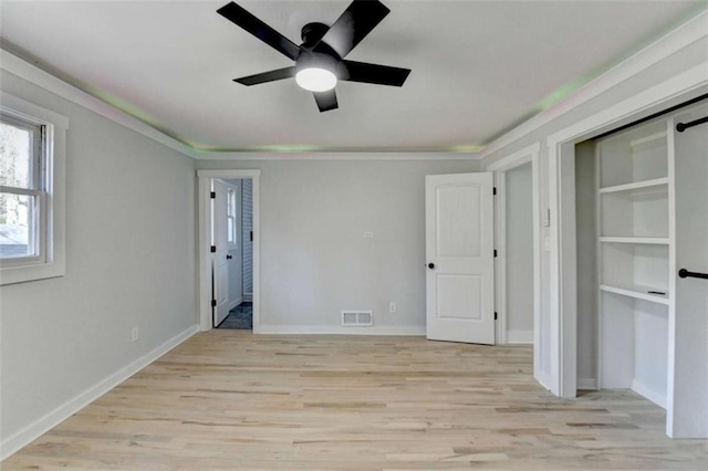 unfurnished bedroom with crown molding, ceiling fan, and light wood-type flooring