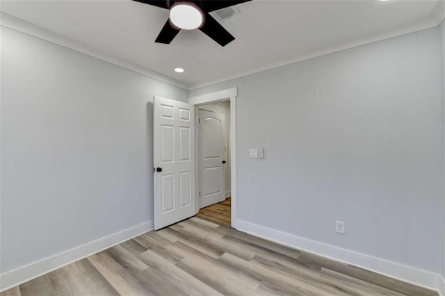 spare room with ceiling fan, ornamental molding, and light hardwood / wood-style floors