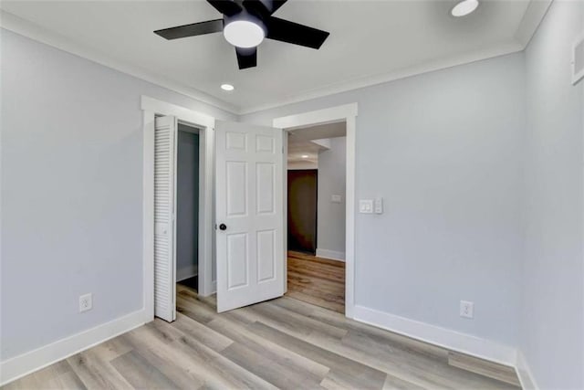 unfurnished bedroom featuring ceiling fan, ornamental molding, and light wood-type flooring