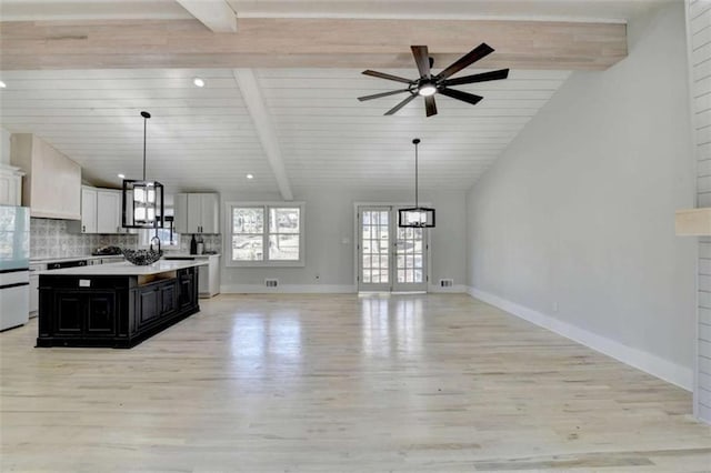 kitchen featuring pendant lighting, lofted ceiling with beams, white cabinetry, decorative backsplash, and white fridge