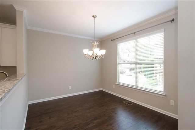 unfurnished dining area featuring dark wood finished floors, ornamental molding, baseboards, and a chandelier