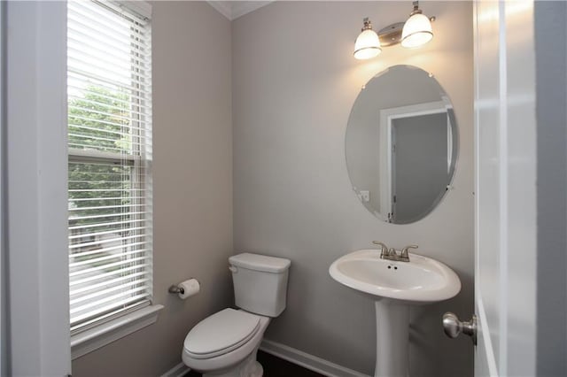 half bath featuring toilet and a sink