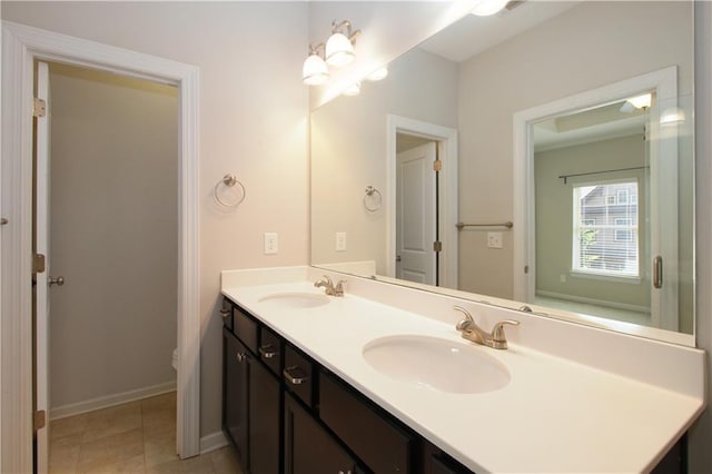 full bathroom featuring double vanity and baseboards