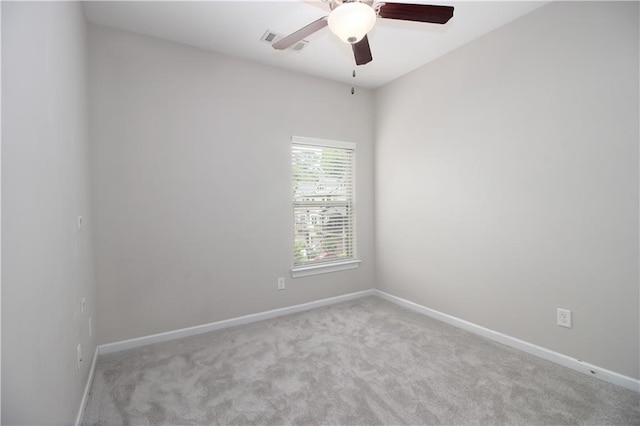 empty room featuring carpet floors, ceiling fan, and baseboards