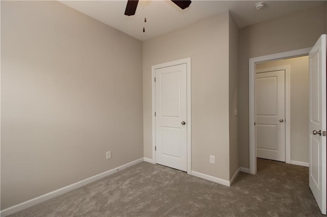 unfurnished bedroom featuring carpet, baseboards, and a ceiling fan