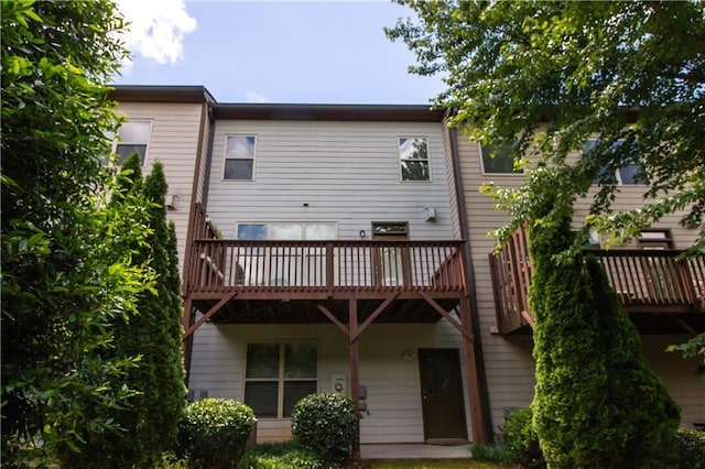 back of house with a wooden deck