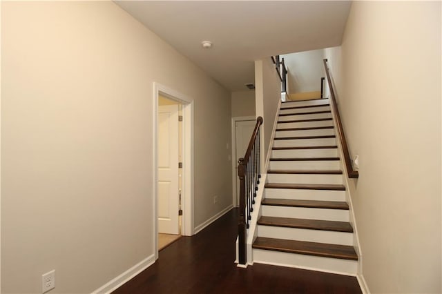 stairway featuring wood finished floors and baseboards