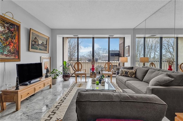 living room featuring marble tiled flooring and a textured ceiling