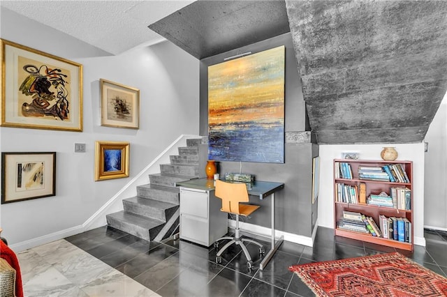 office area featuring baseboards and a textured ceiling