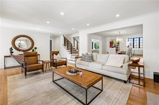 living area featuring stairs, recessed lighting, and light wood-style floors